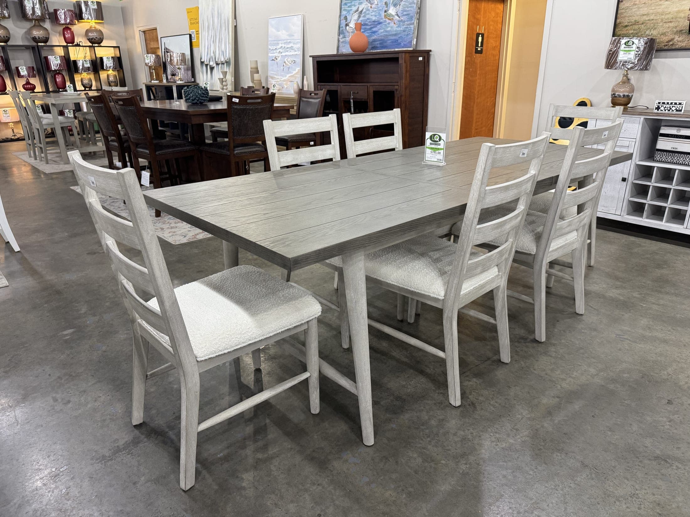 White dining table with ladder-back chairs