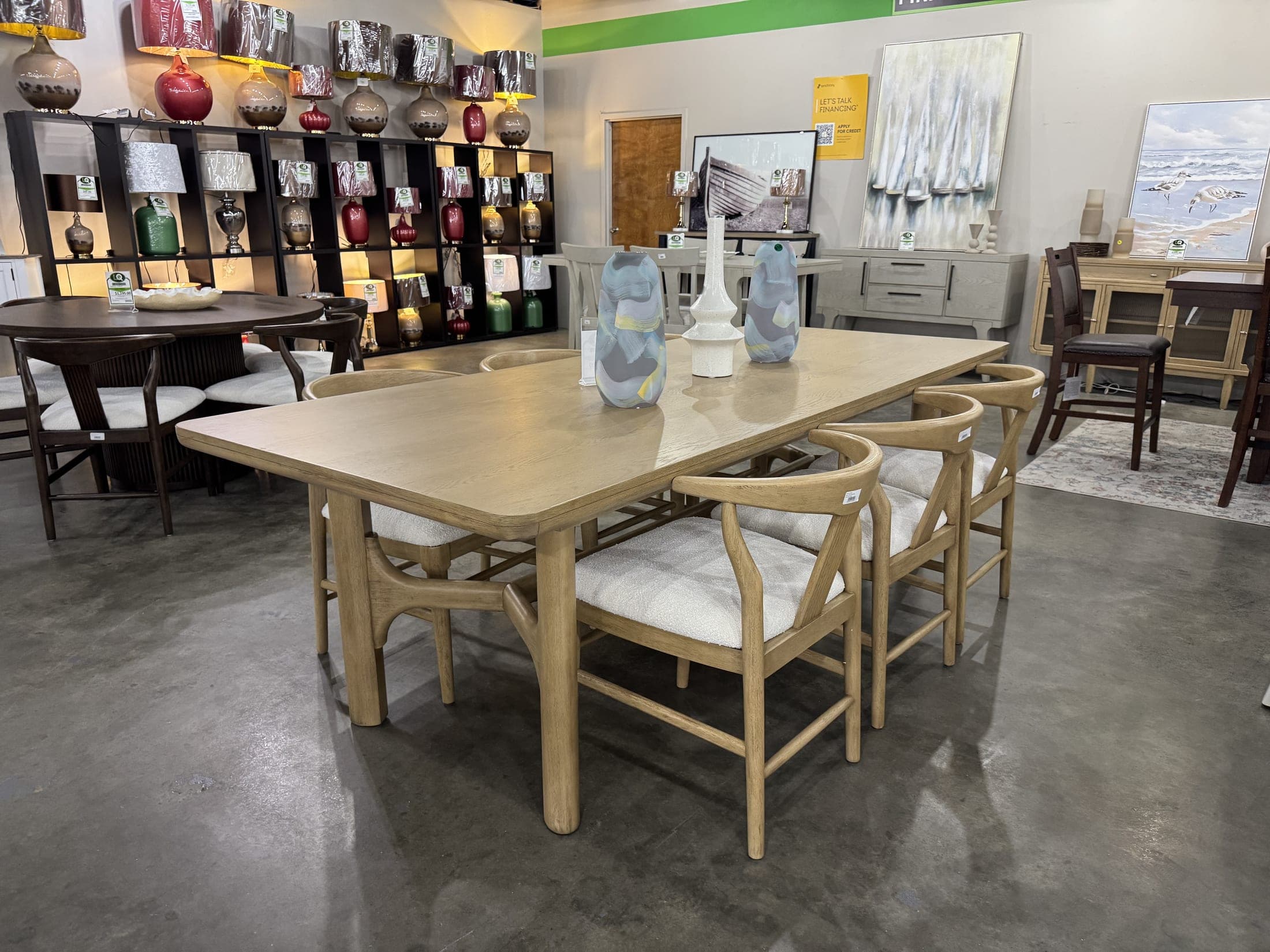 Light-finish dining table with woven-back chairs