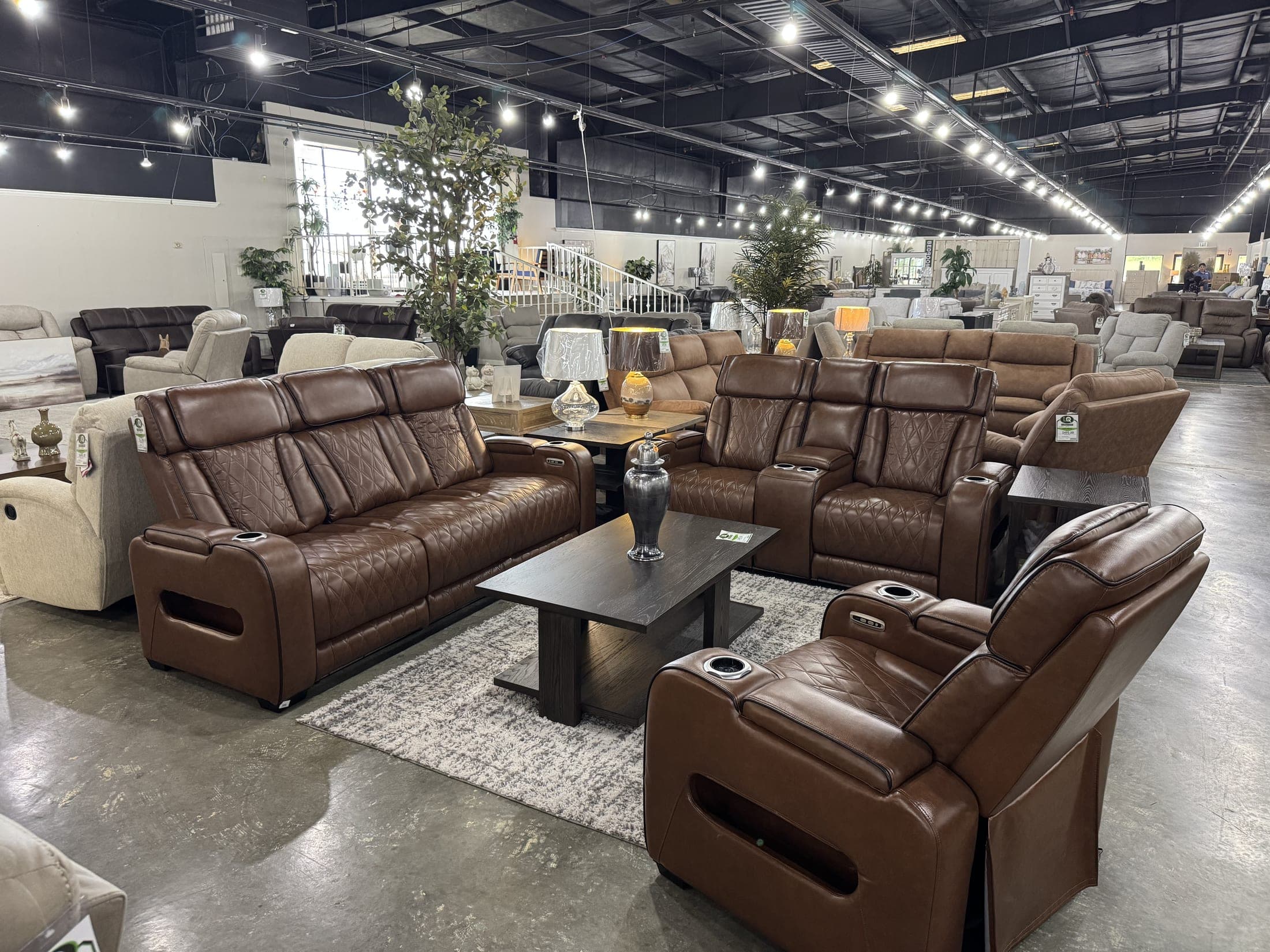 Brown upholstered power reclining sofa and recliner with console and cup holders