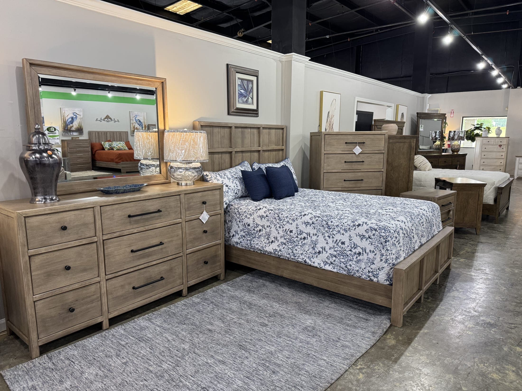 Bedroom grouping with upholstered bed, dresser and mirror