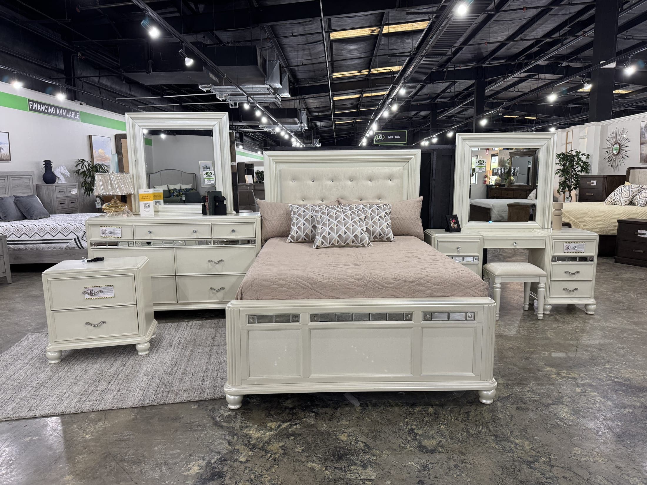 White bed with matching mirror and dresser