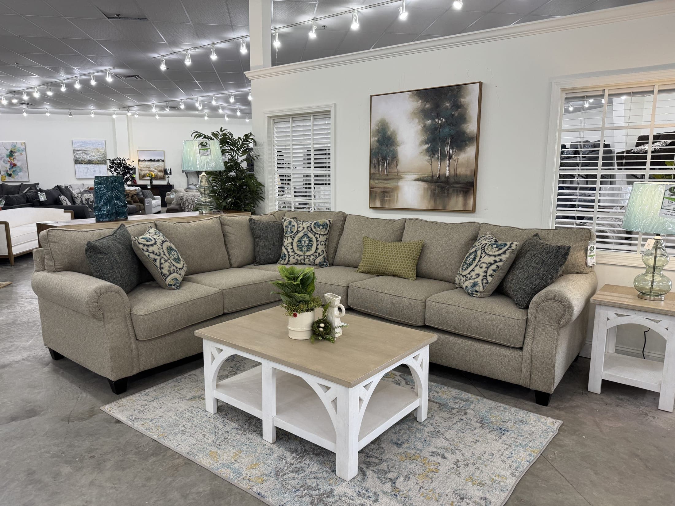 Beige upholstered sectional with a white coffee table