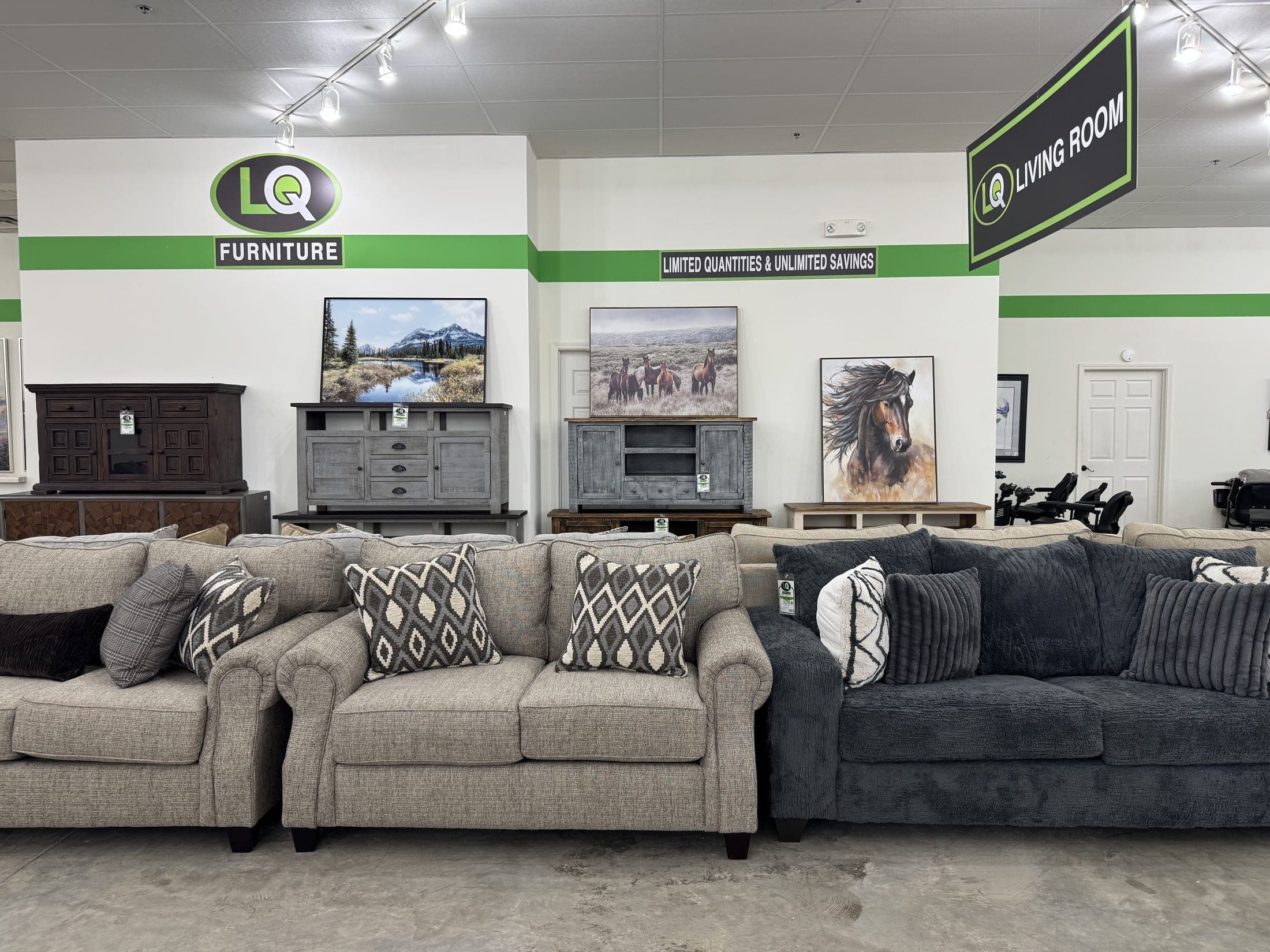 Light beige sofa beside a charcoal sofa with patterned pillows