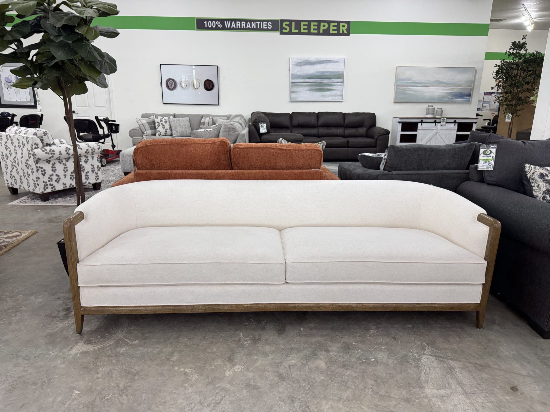 Cream sofa with exposed wood trim beside orange accents