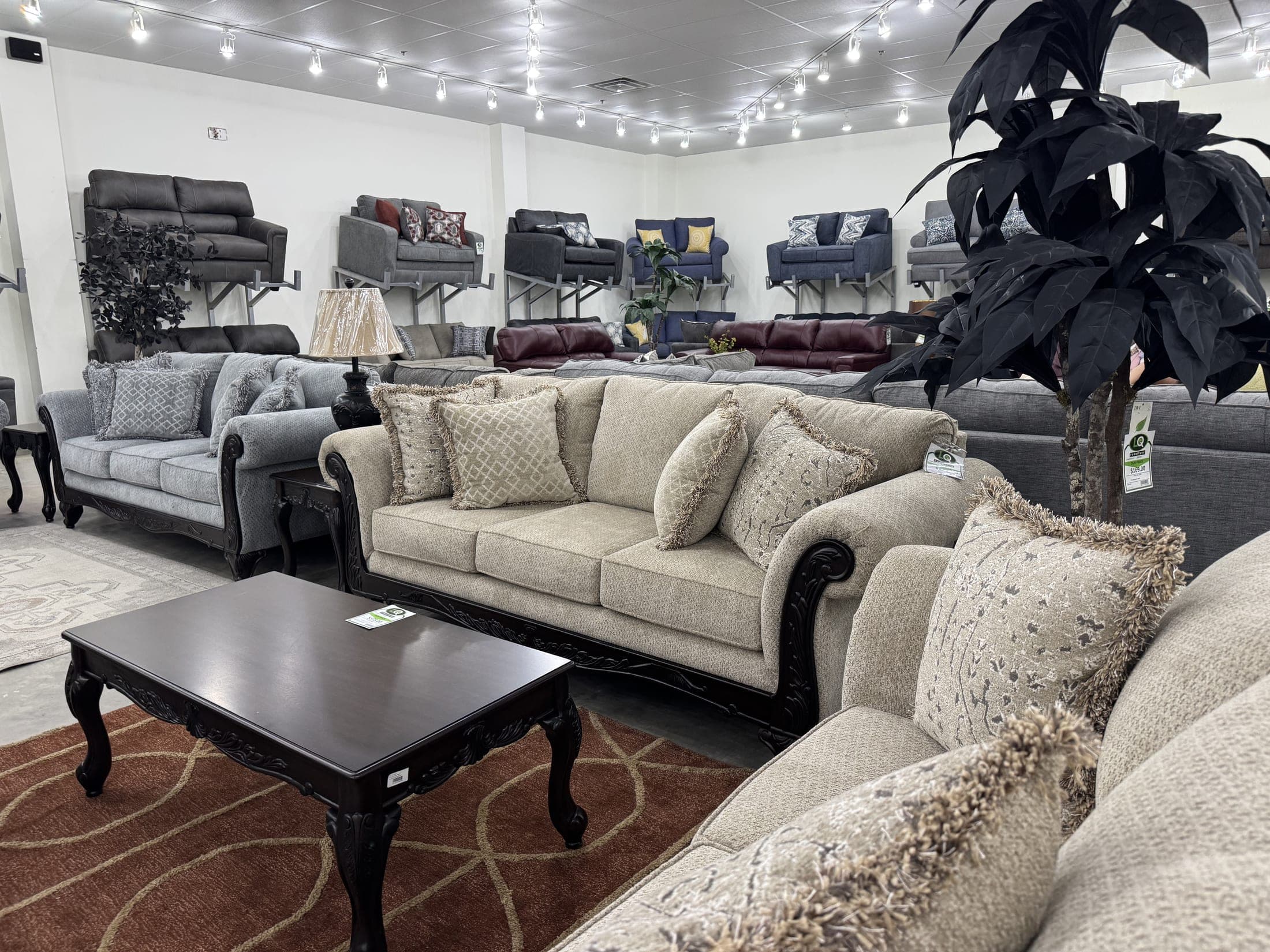 Cream rolled-arm sofa with a dark traditional coffee table